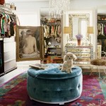 Blue tufted ottoman in a celebrity dressing room with chandelier and dog