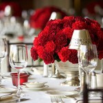 Table setting with red flowers