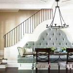 Dining area with tufted banquette seating and staircase
