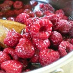 Raspberries cooking in wine syrup
