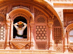 man-in-window-of-fort-palace-jodhpur-at-fort-mehrangarh-rajasthan-india.jpg